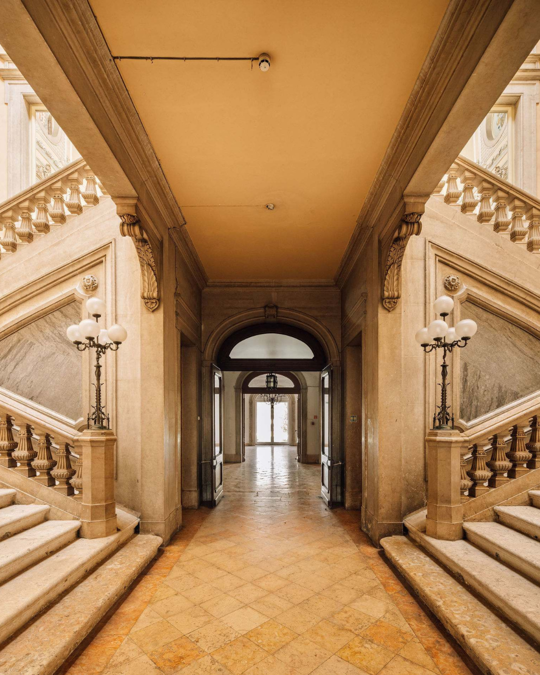 Symmetrical marble staircase and ornate corridor inside a historic Lisbon building during Open House Lisboa