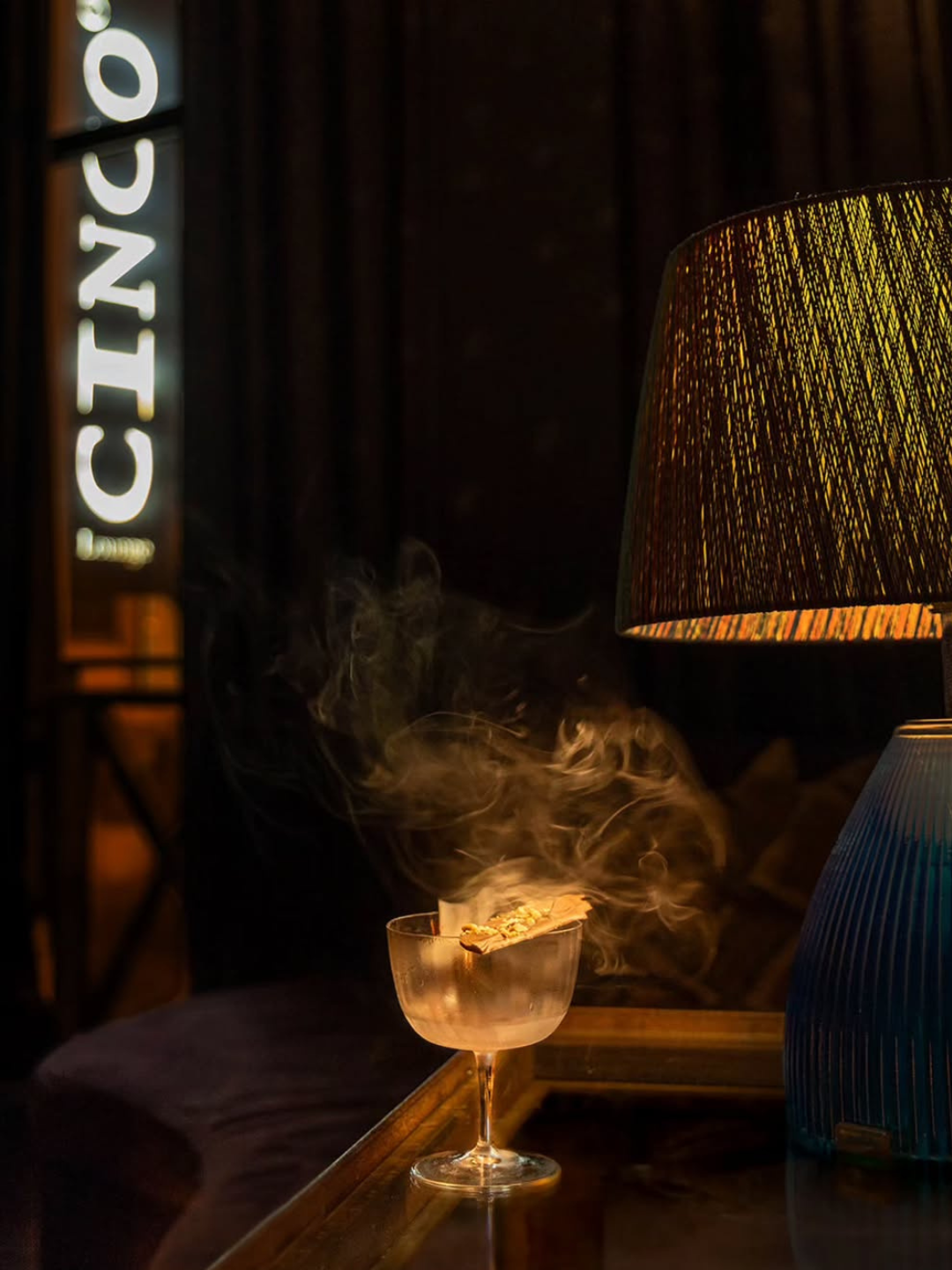 A private cocktail-making workshop at CINCO Lounge in Príncipe Real, Lisbon, with participants learning mixing techniques and Portuguese-inspired recipes in an intimate bar setting.