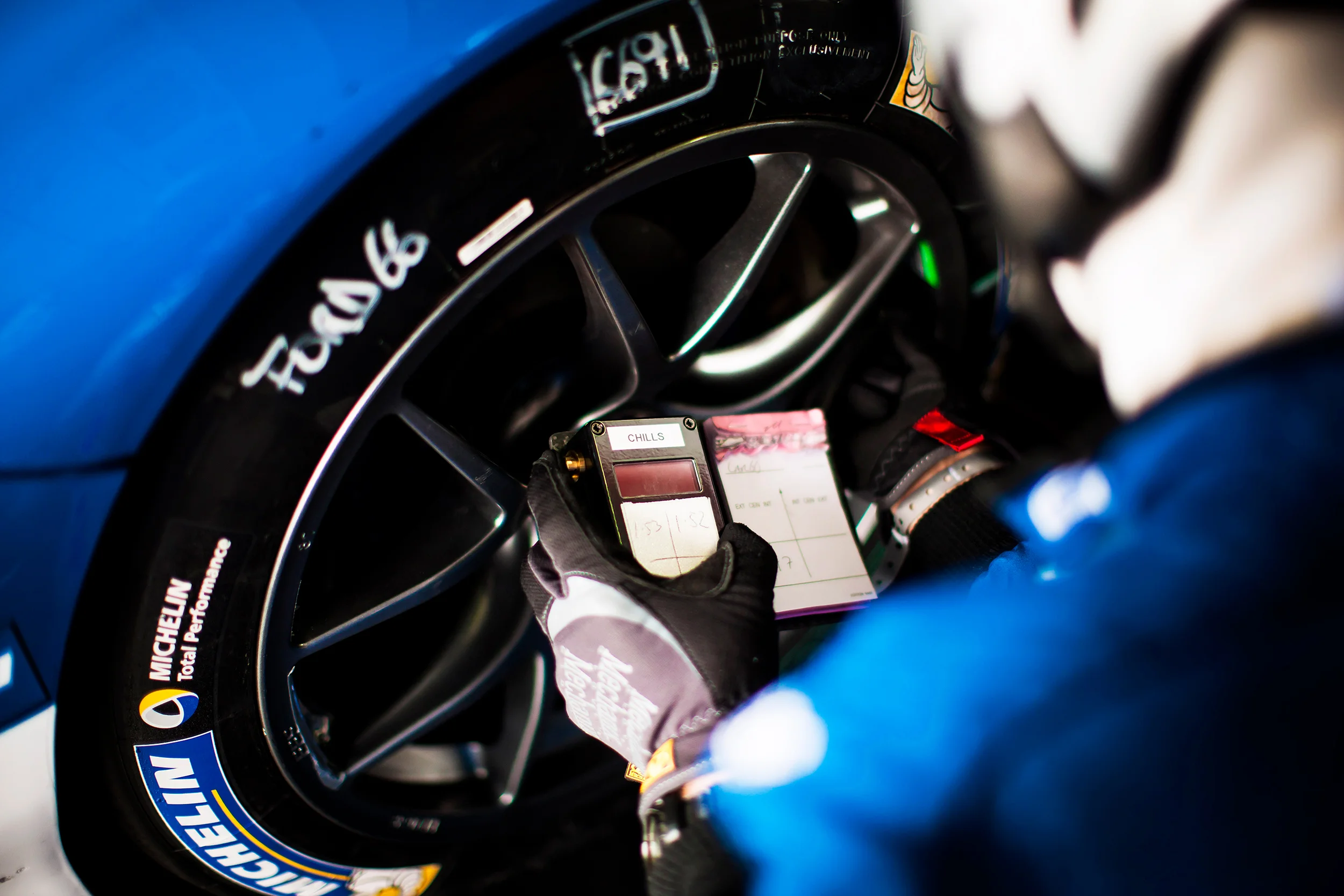 Ford GT team member checking the tyre pressures 