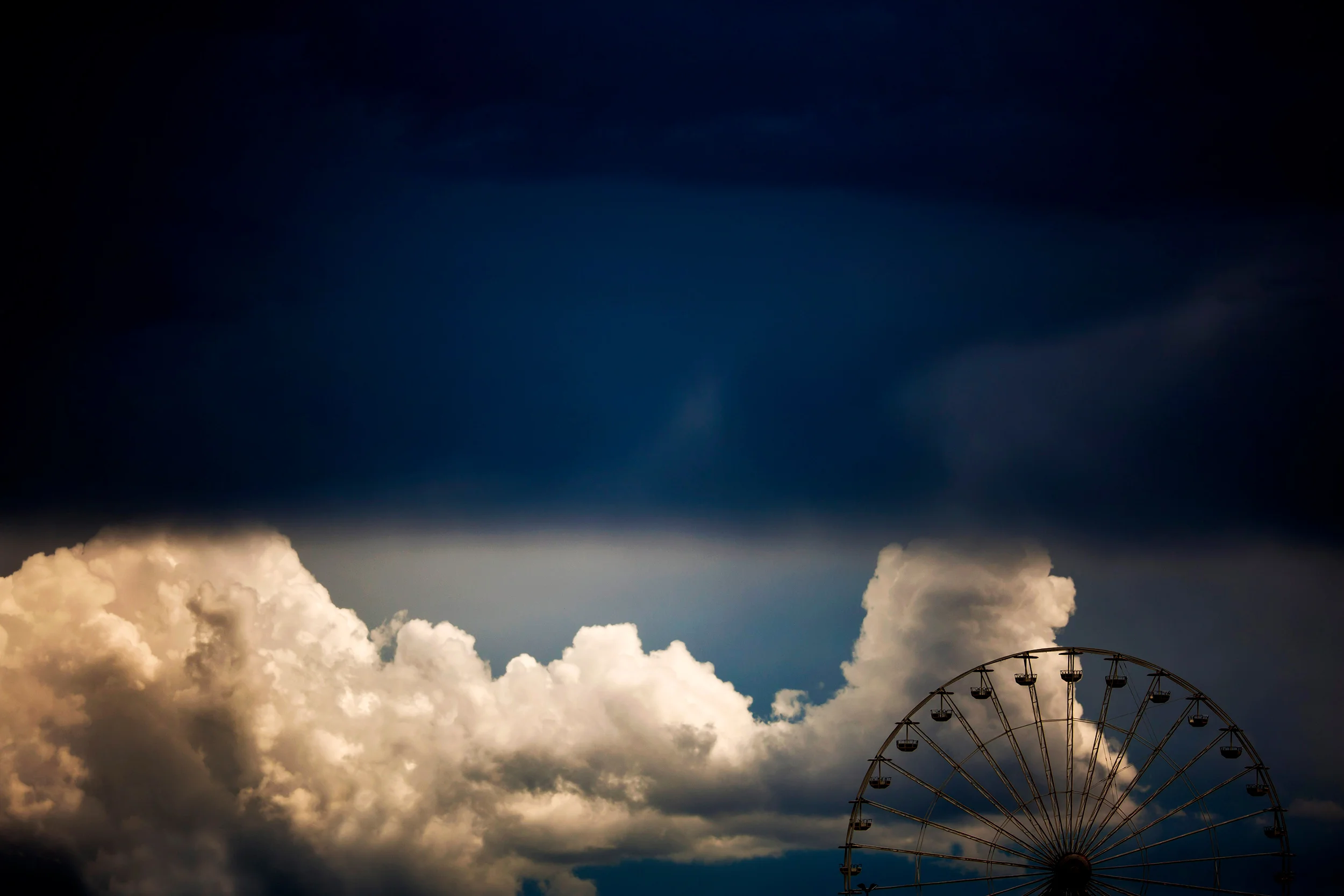 The ferris wheel under a threatening sky
