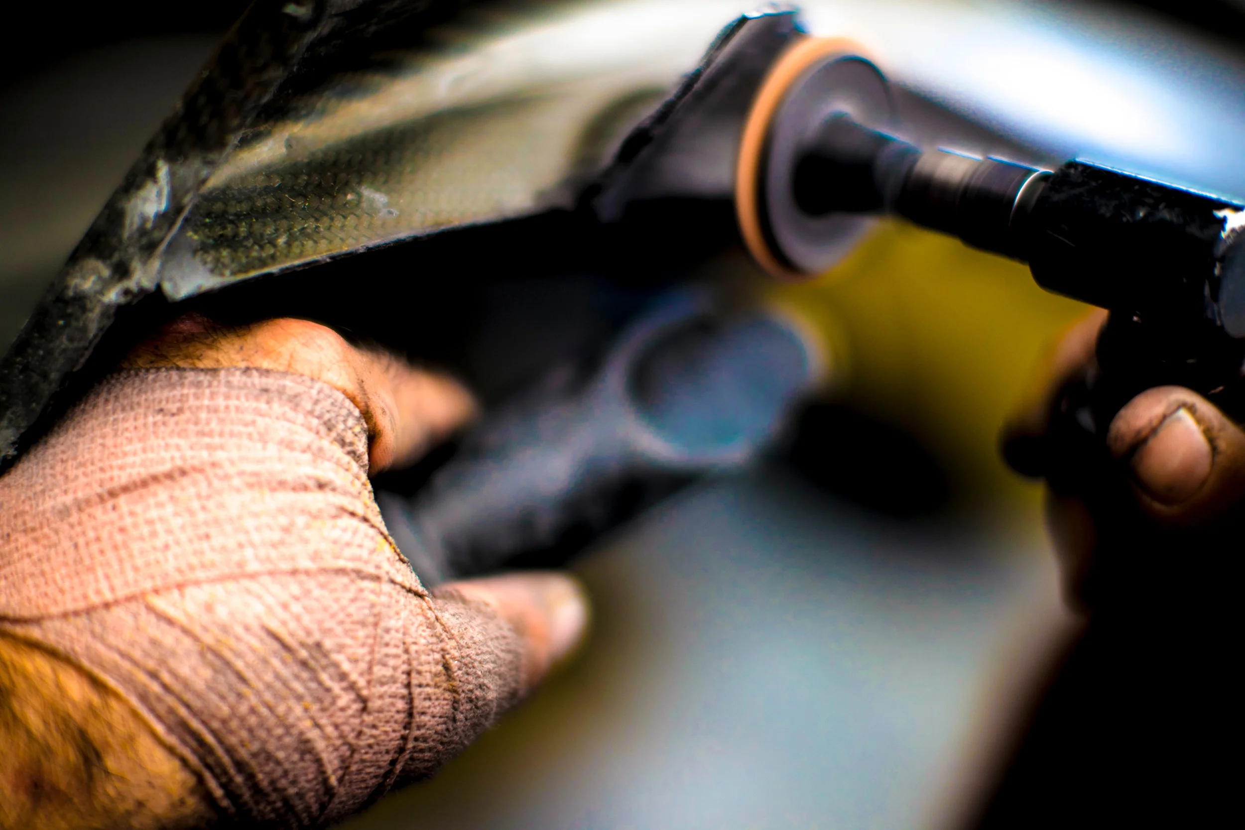 A Ford team member repairs body work from the Ford GT