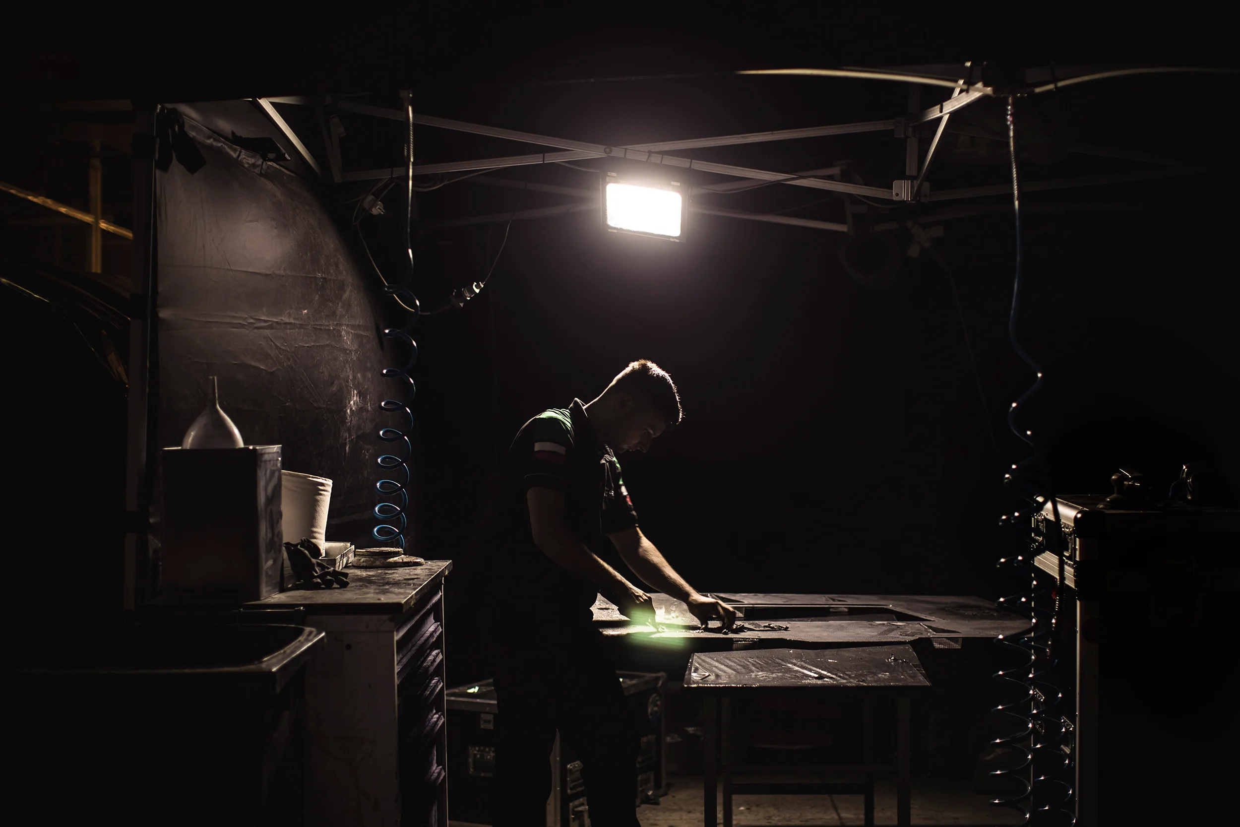 A Ferrari team member works on some carbon fibre