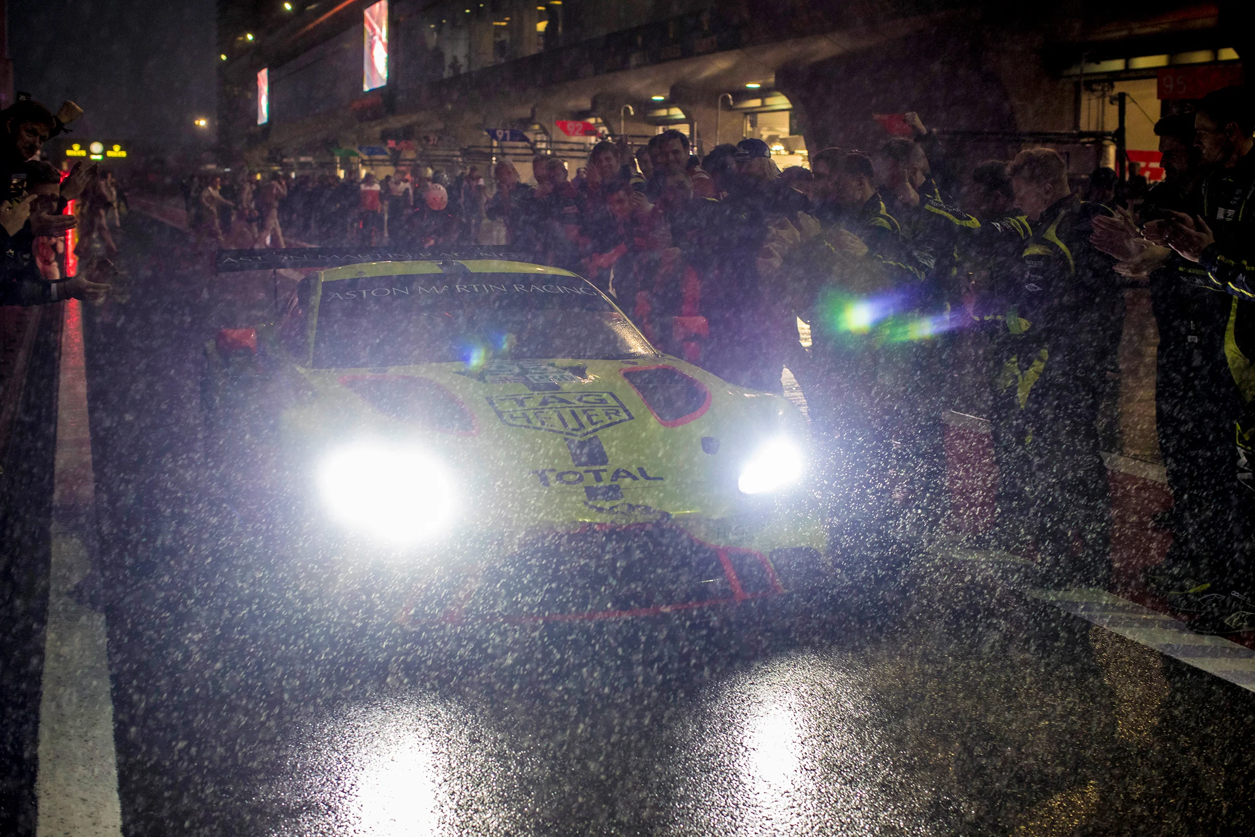 The team celebrate as Nicki Thiim passes in the pit lane