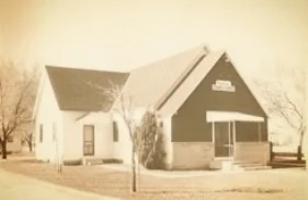 After meeting in a borrowed church building, a tent and a house, the first permanent building was constructed in 1945.