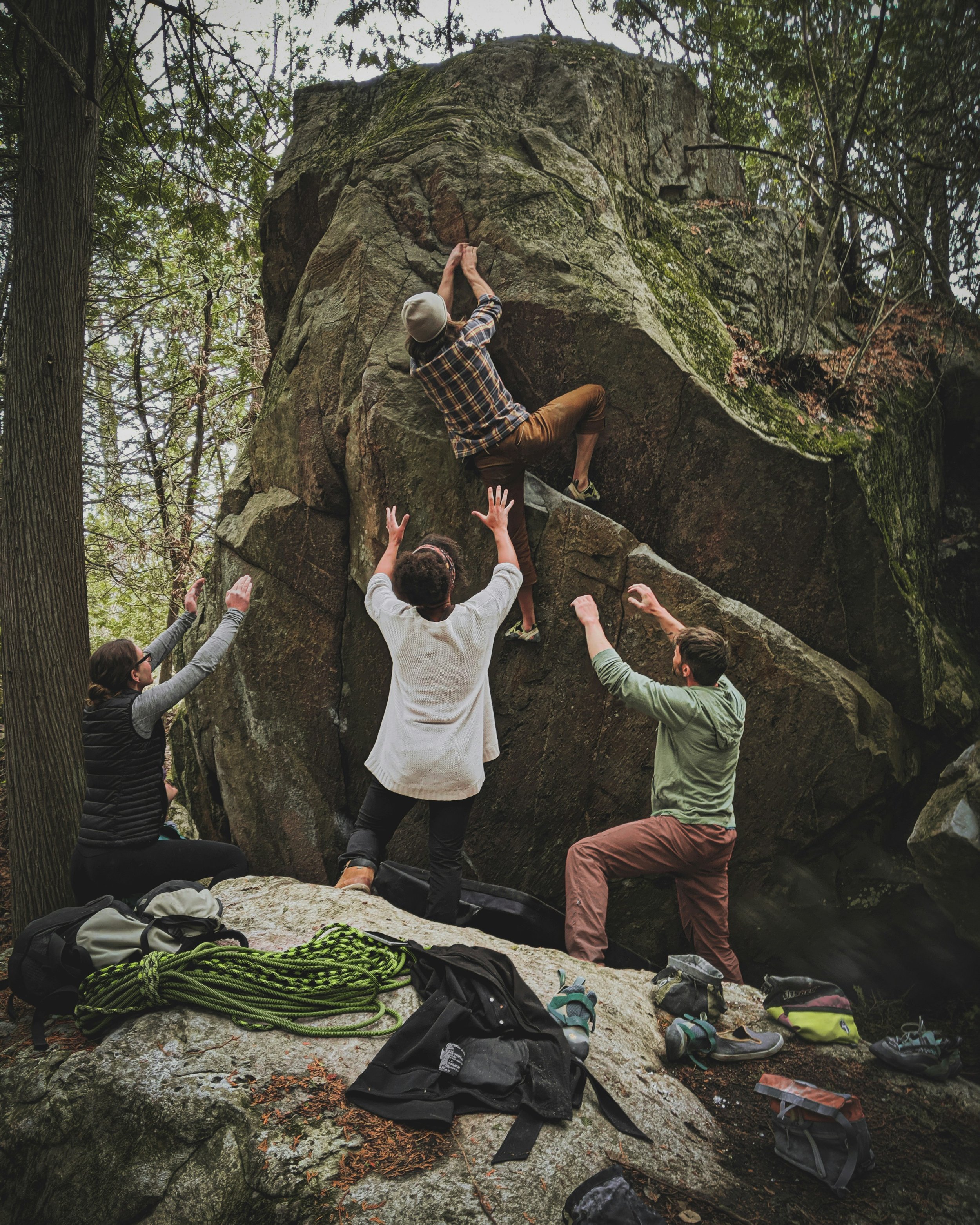 Climber with people spotting and supporting