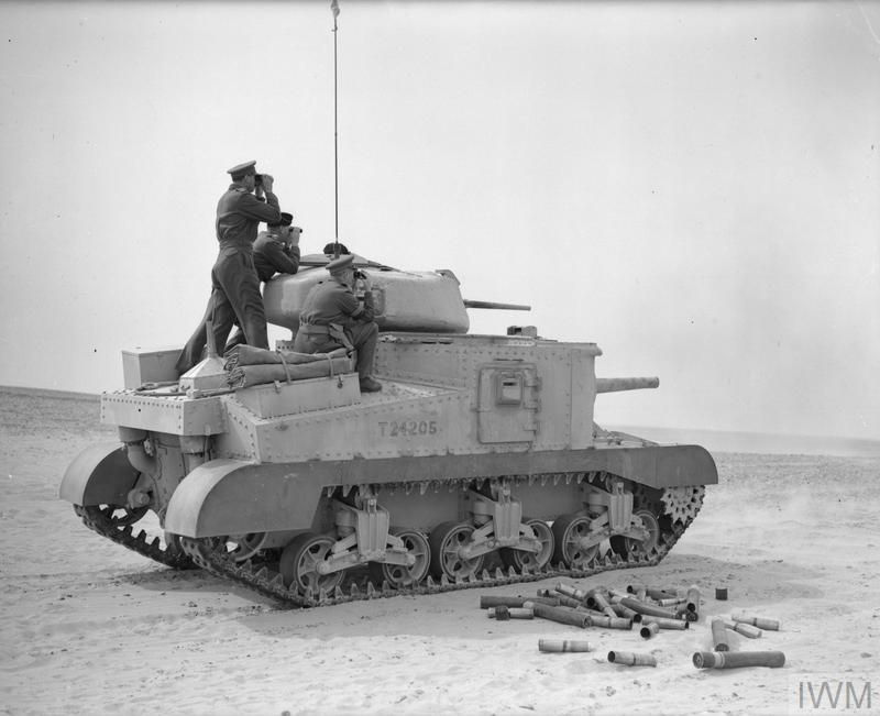 The Commander in Chief, General Sir Claude Auchinleck, (farthest from the camera) and Major General Campbell, VC, standing on a Grant tank, watching as it fires at a practice target in the Western Desert, 17 Feb 1942. IWM photo E 8458