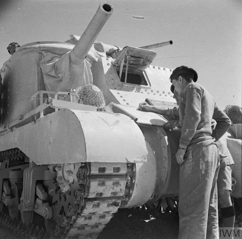 Royal Tank Regiment officers study a map before going into battle in their Grant tanks, 4 Jun 1942. IWM photo E 12864