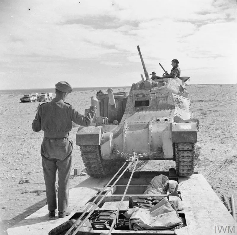 Men of the Royal Electrical and Mechanical Engineers guide a Grant tank onto a Scammell tank transporter to take it to a light repair workshop, 19 Jan 1943. IWM photo E 21405