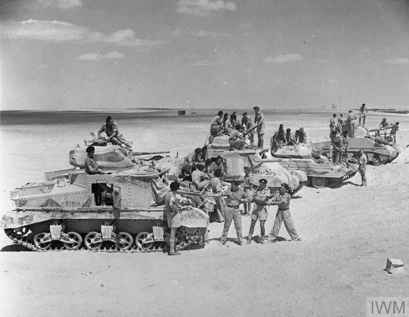 Trainee crews practicing gun cleaning on Grant, Crusader and Sherman tanks. IWM photo E 4211E