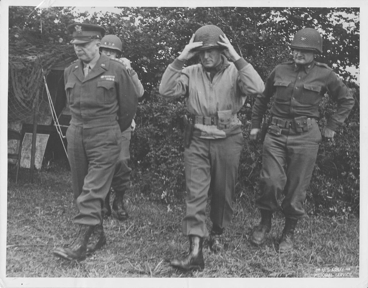 Major General Brooks walking with General Eisenhower, Lieutenant General Bradley and Colonel Palmer. The division landed on Omaha Beach on June 9, 1944. The 2nd Armored Division was committed immediately. Brooks was cited for gallantry in action during the period August 2 to 6 for making repeated visits to forward elements of his command. Exposing himself to hostile observation and fire, he expedited the commitment of the division and personally assisted in the organization of continuing attacks by subordinate units in assault on enemy strong points. That display of gallantry and leadership, without regard to his personal safety, earned for him the Silver Star. Brooks personally pushed the 2nd Armored Division into being among the first Allied divisions on Belgian soil and was the first Allied division commander to enter that country by assault. An incident during the drive into Belgium occurred when a corps staff officer came to Brooks' 2nd Armored command post and told the general that he had a mission for the division that he feared was impossible—to be in Ghent in two days. The staff officer's eyes bugged out when the general said, "Tell the corps commander it's in the bag. We'll be there." After the officer departed, Brooks turned to his chief of staff, Colonel Charles D. Palmer , and said, "Where the hell is Ghent?" They made the objective behind enemy lines and outside their operational zone, with hours to spare.
