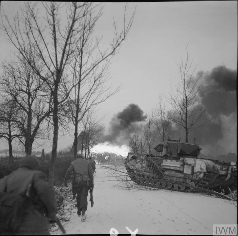 Churchill Crocodile flamethrowers in action against the village of St Joost, north of Schilberg, during an attack by 1st Rifle Brigade, 20 Jan 1945. IWM photo B 13944.