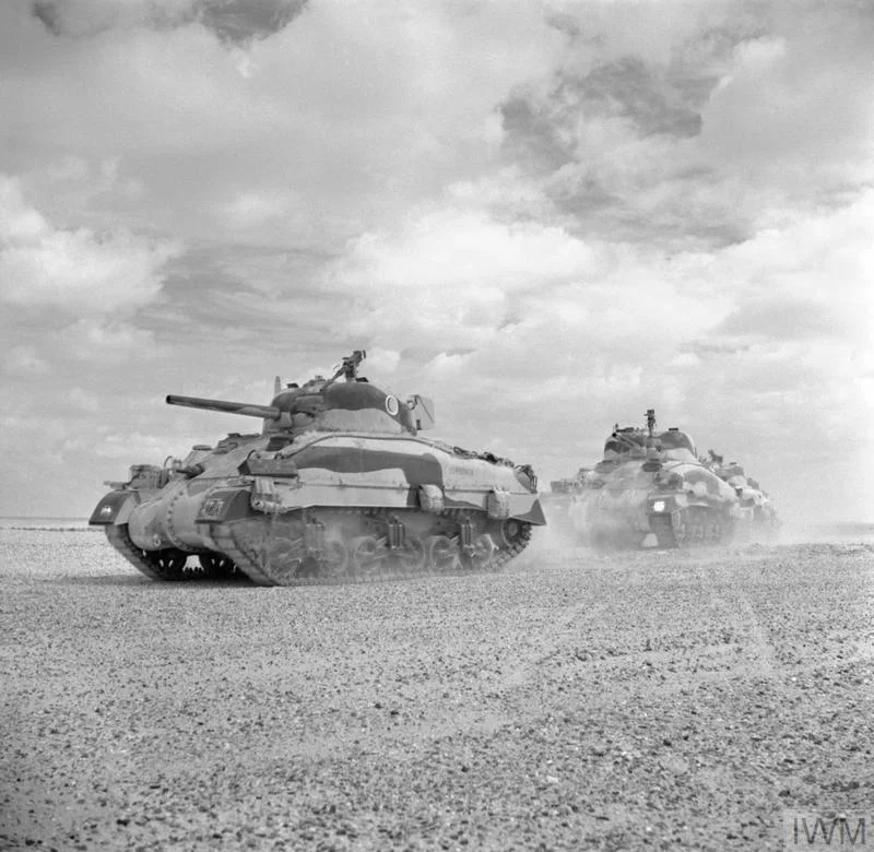 Sherman II tanks of the Queen's Bays (2nd Dragoon Guards), 2nd Armoured Brigade, moving up to the Alamein line, 24 Oct 1942. IWM photo E 18380.