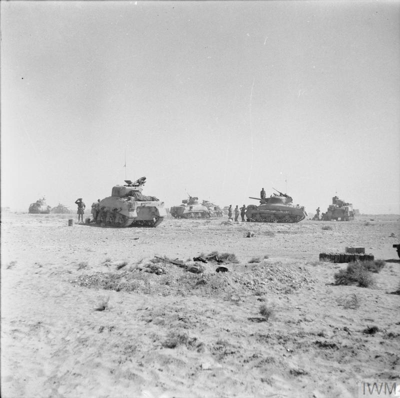 Sherman tanks of 8th Armoured Brigade waiting just behind the forward positions near El Alamein before being called to join the battle, 27 Oct 1942. IWM photo E 18531.