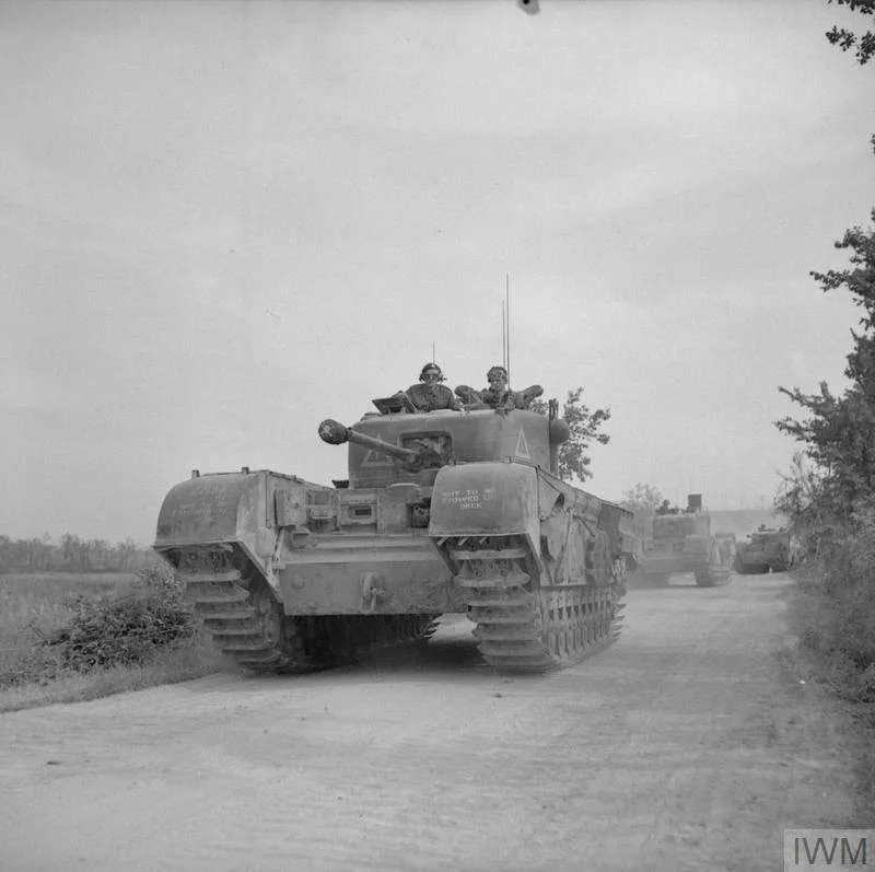A Churchill tank leads a troop of Sherman flail tanks of 79th Armoured Division during the assault on Boulogne, Sep 1944. A French sailor can be seen manning the radio in the Churchill, guiding the vehicles towards their objective. IWM photo HU 104161.