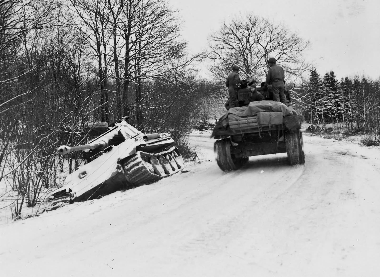 2AD Sherman passes a German Panther tank, Grandmenil, Belgium.