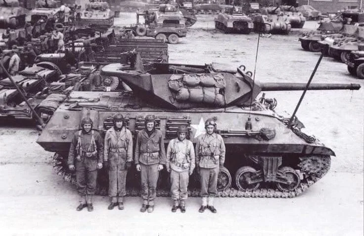 Crew of M10 GMC “Bouncing TNT”, B CO, 803rd Tank Destroyer BN, at a depot in Cornwall, England. The Battalion was attached to 2AD. Apr 1944.