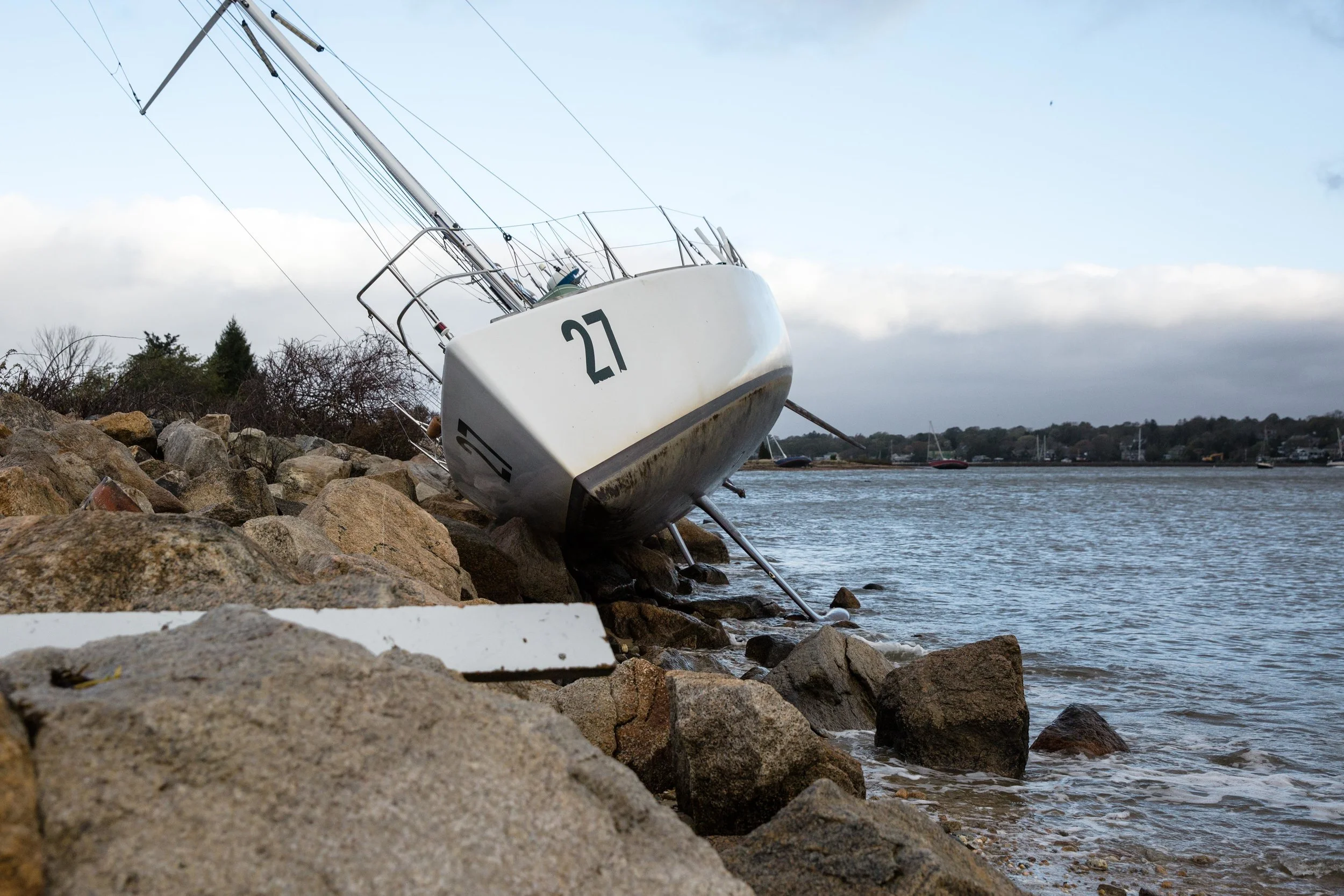 A sailboat rests on the rocks near Smithneck Road.