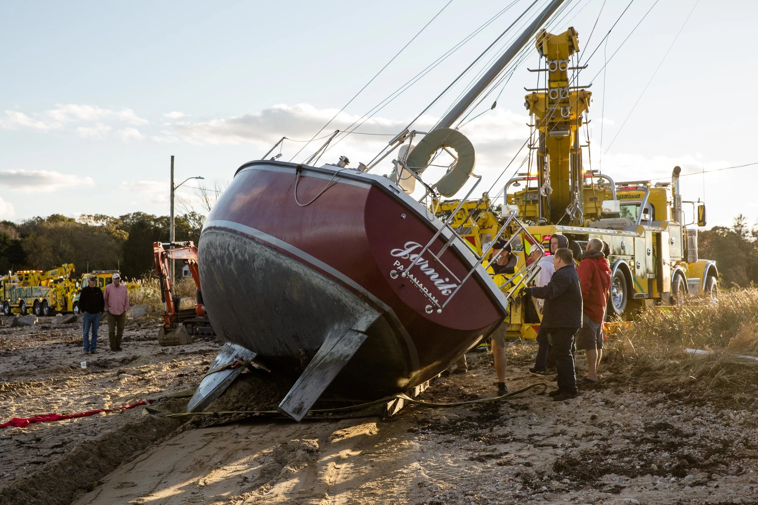 The sailboat is dragged out of the water and onto the beach.