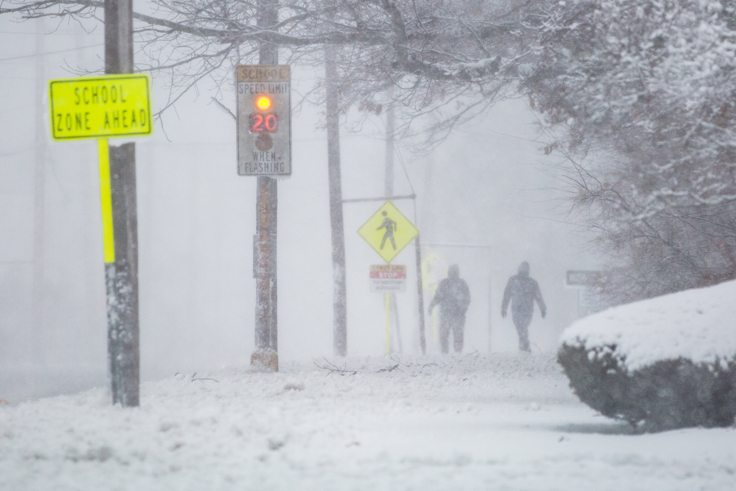  Two brave souls walk along Dartmouth Street during the blizzard. - South Dartmouth, MA 