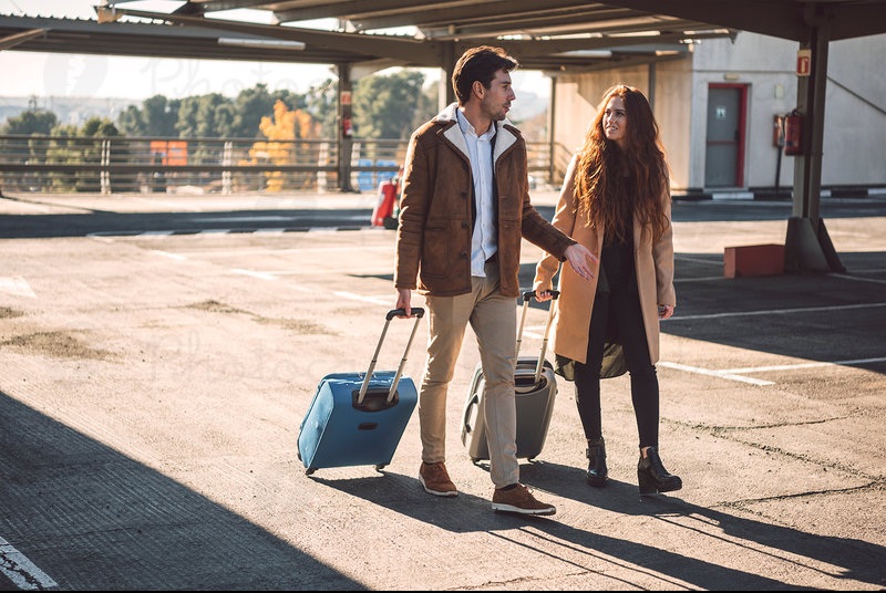 2314753-couple-walking-and-talking-with-luggage-woman-photocase-stock-photo-large.jpeg