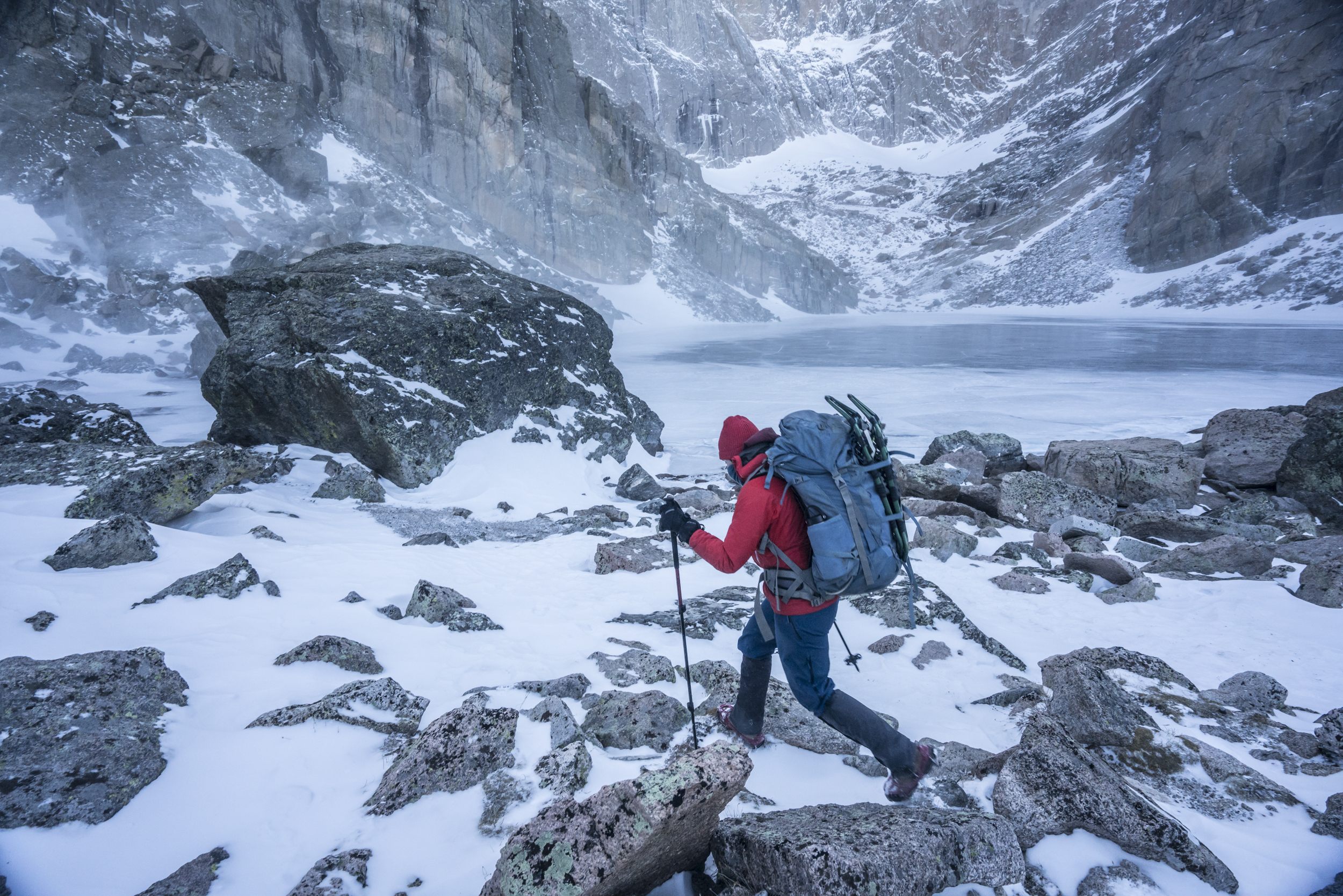  Appreciating the calm complexities of cold, a backpacker explores the harsh winter wilderness that is Rocky Mountain National Park's Chasm Lake.  Chasm Lake, Colorado 