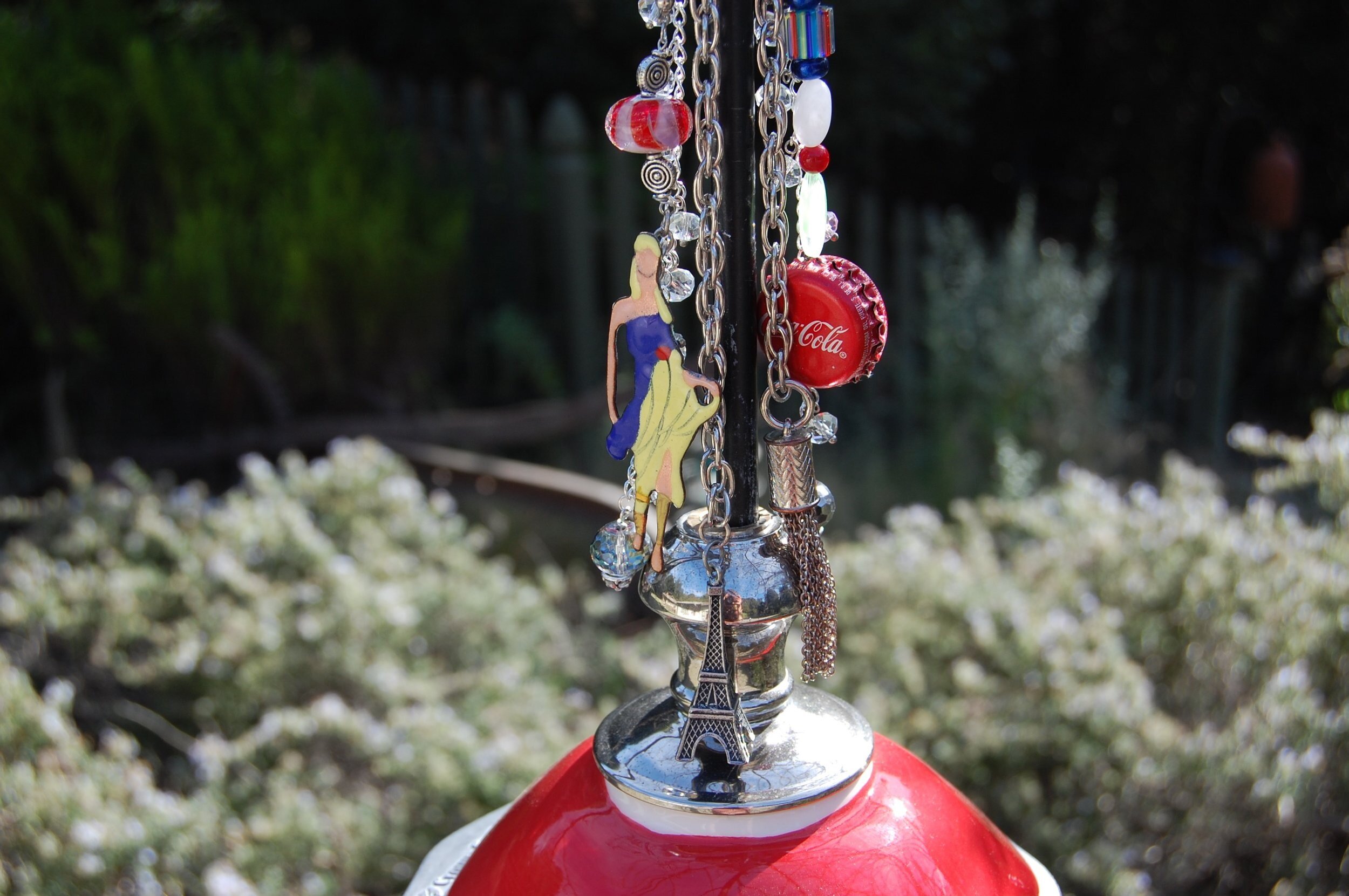 red bird feeder with Paris theme