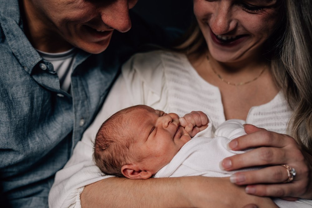  Lifestyle Newborn Session in St. Louis, MO with new baby and new parents in their neutral, Harry Potter themed nursery. 