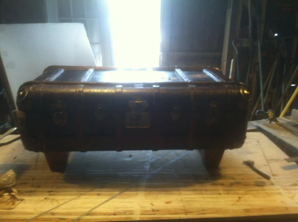 Coffee table custom made from an antique steamer trunk.