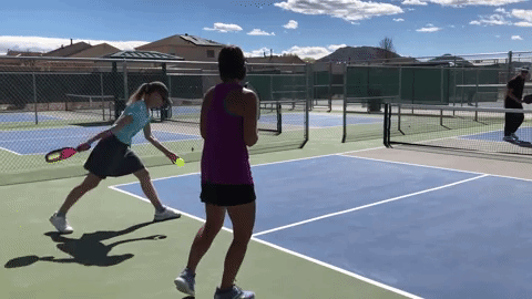 Using a conventional ‘bowling’ serve, the player in green appears to use her serve merely to start the point. This makes it more likely a difficult, deep return will be sent. Her late set-up leads to a third shot that is high and without clear purpose.