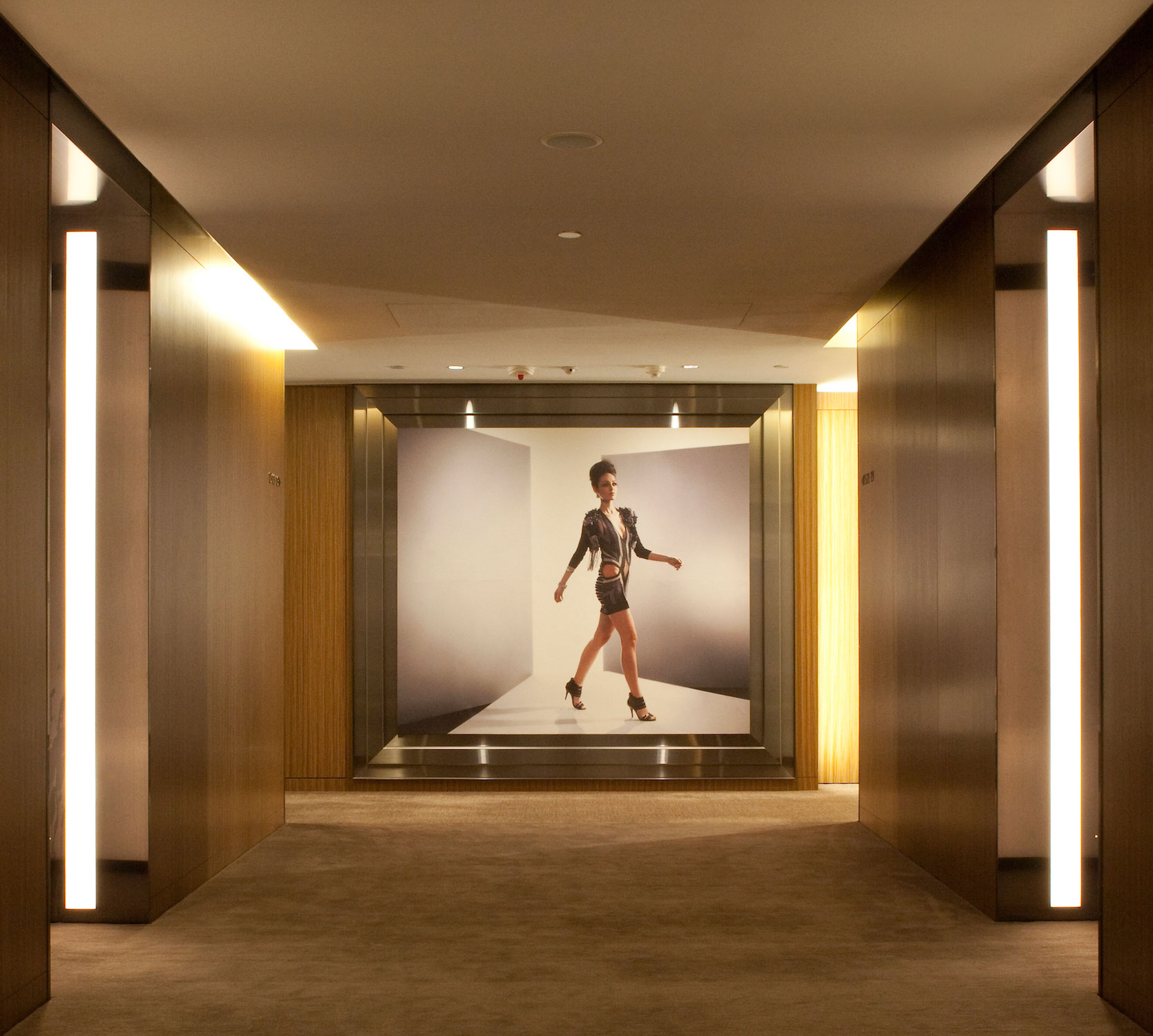 The timber clad, suspended spiral staircase at the entrance echoes the sculptural form of the lobby seating, constructed locally using simple plywood forms and internal lighting.The ‘silver box’ ballroom uses a custom designed prismatic glass crystal ceiling feature instead of conventional chandelier.