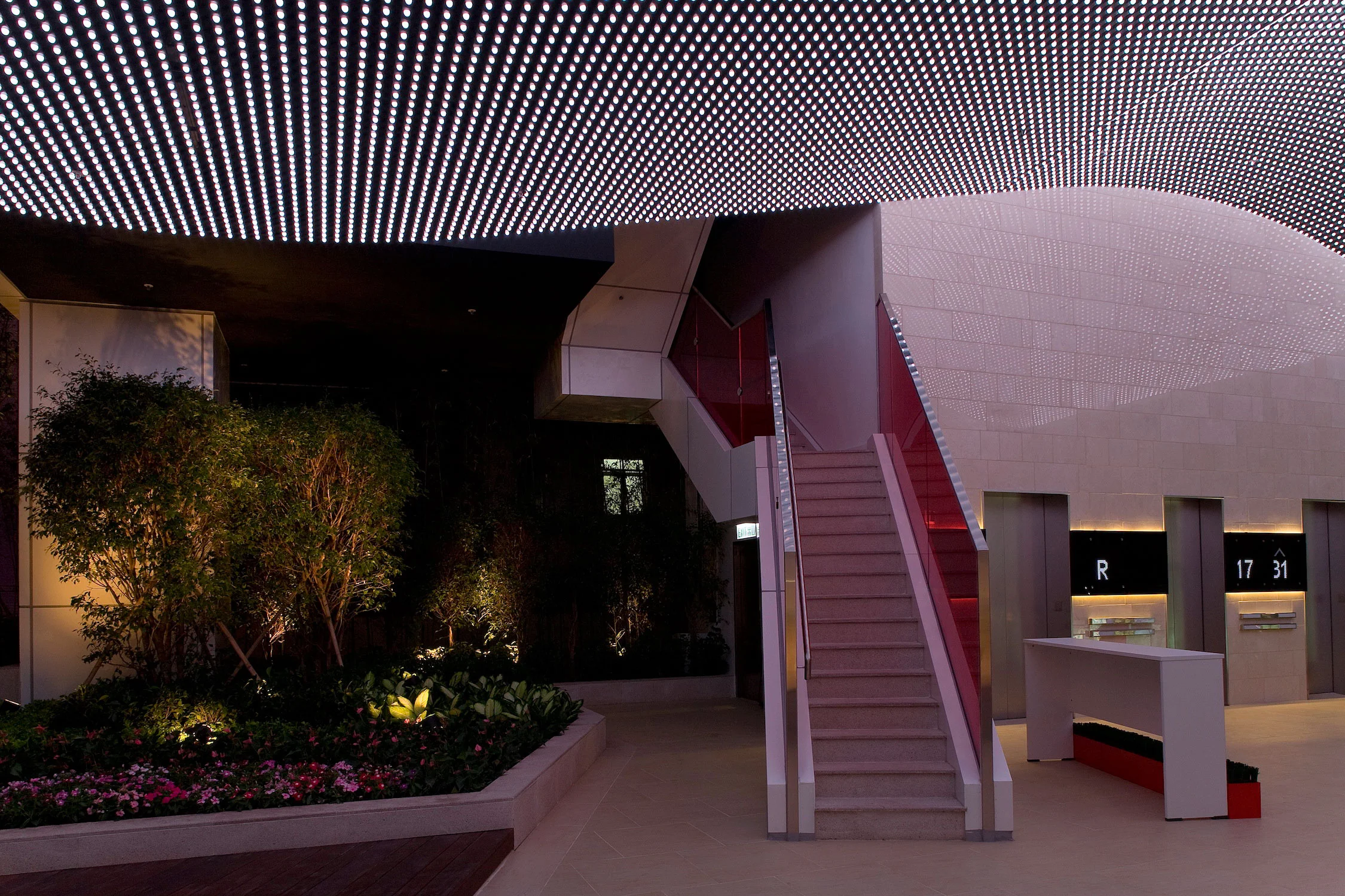 This 28 storey building is on a 4,000 s.f. sandwich site with 2 street frontages. Within the building we incorporated a series of open public spaces, such as the outdoor stair and terrace area which is above a 3 storey commercial podium. This terrace visually links the 2 streets and creates an urban space for public activities and private events. A wavy LED ceiling defines the space and connects visually to the 2 streets. A tall “urban canyon” like space with a series of escalators link visitors from the street to this space.