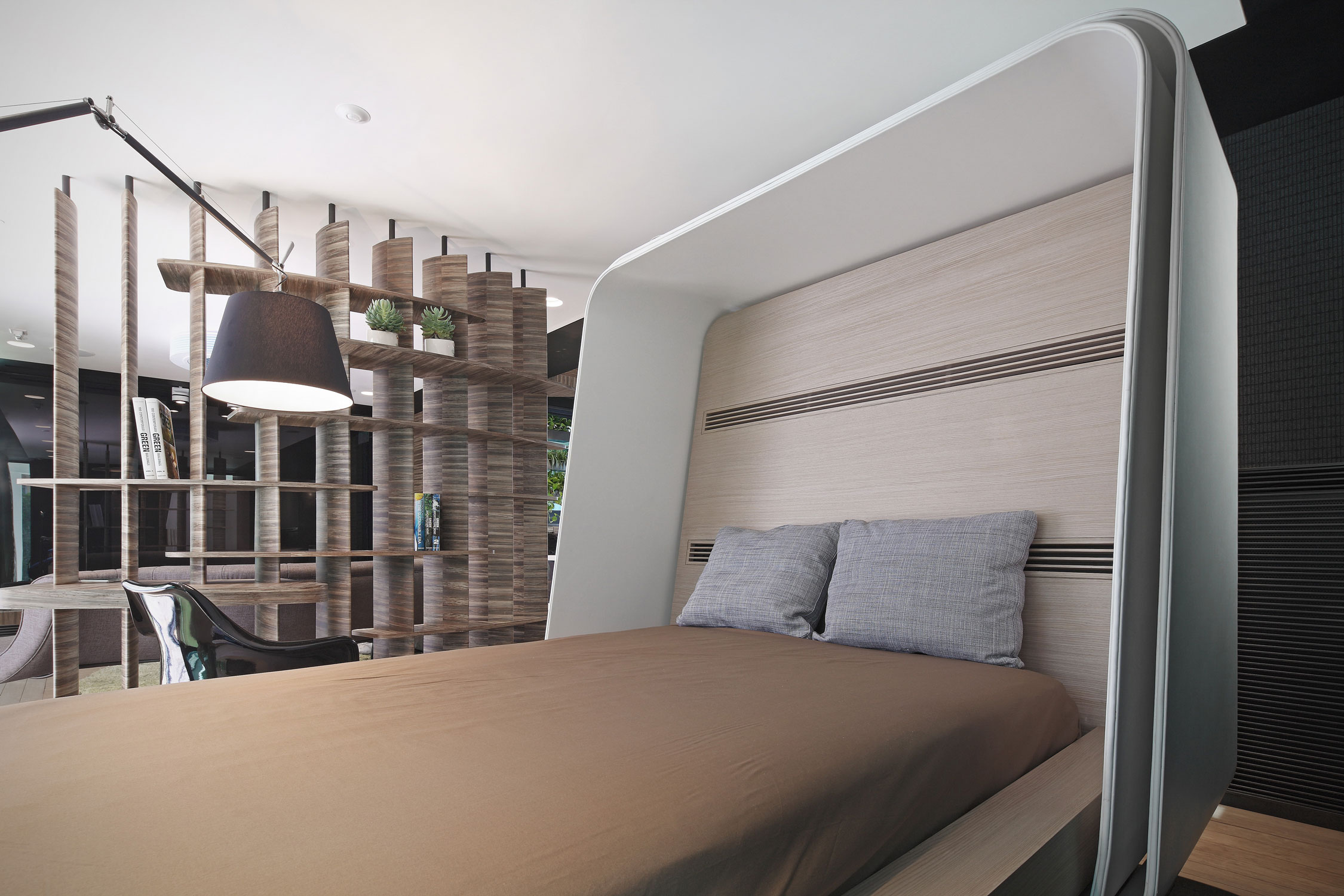 A custom designed bed with a retractable cover provided with a mini-air conditioner creates micro condition for comfortable sleeping with low energy consumption. The permeability of the spaces allows daylight and natural breeze to come through to every part of the home.