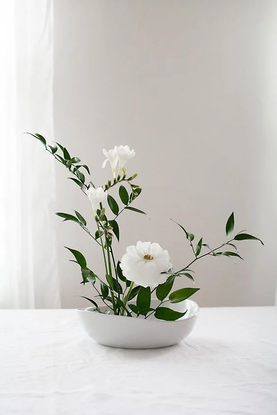 A beautiful, light, minimal floral arrangement creates a pleasing pop of greenery while maintaining a clean aesthetic.