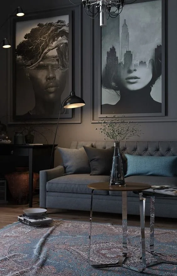 Dark, abstract photography create a sense of comfortable disconnect in this dark living room.