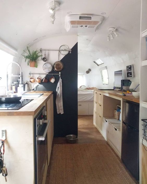 A tiny, yet airy kitchen in a small mobile home .