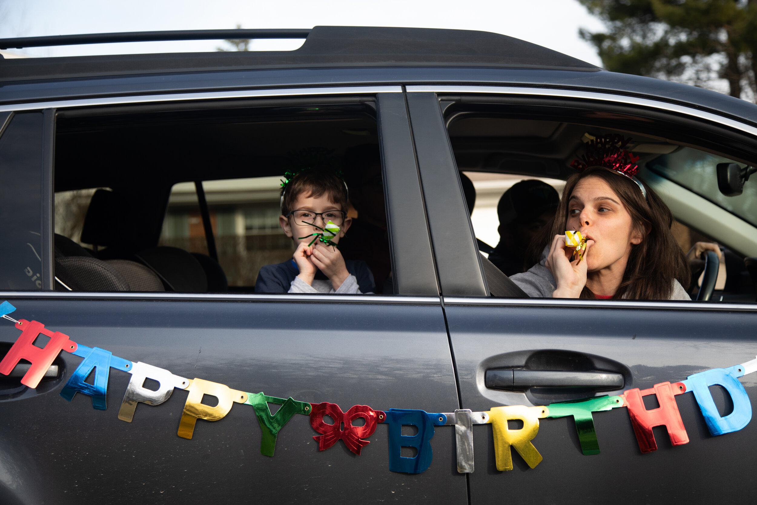  Dana Baer and her son, Jacob, wish Avery Slutsky a happy 6th birthday during a drive-by birthday celebration to maintain social distancing in West Bloomfield Township, Michigan. (Emily Elconin for REUTERS) 