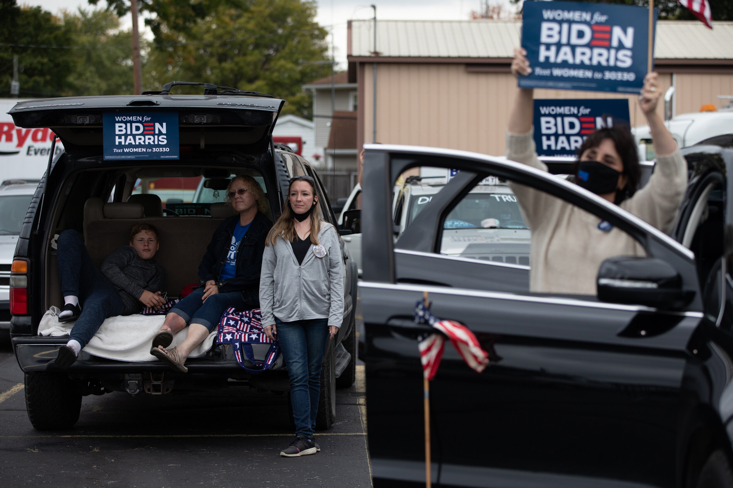  Attendees listen as Former Vice President Joe Biden speaks about his “Build Back Better” agenda during a drive-in rally for a campaign event for union workers and supporters at UAW Local 14 Hall in Toledo, Ohio, on Oct. 22, 2020.. (For The New York 