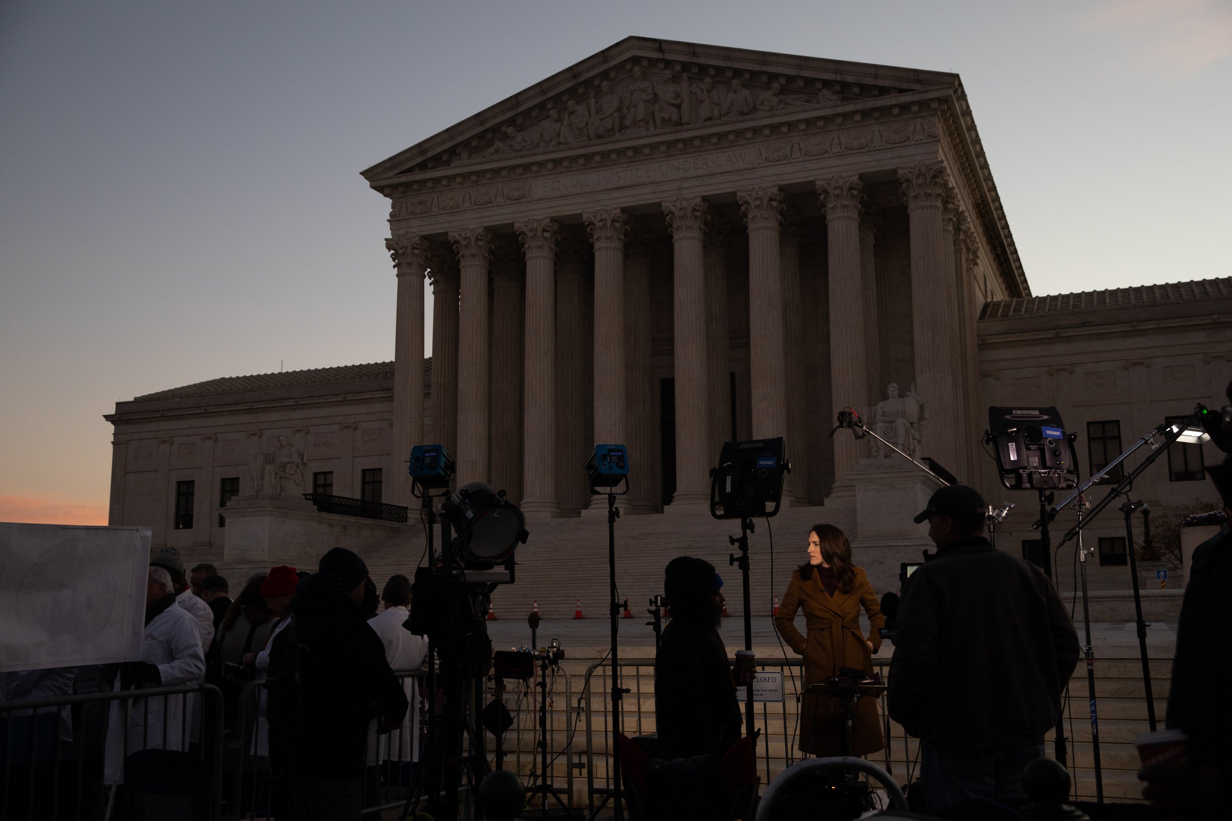  News organizations gather outside the U.S. Supreme Court in Washington, D.C., U.S., on Wednesday, Dec. 1, 2021. The Supreme Court's conservatives suggested they are poised to slash abortion rights and uphold Mississippi's ban on the procedure after 