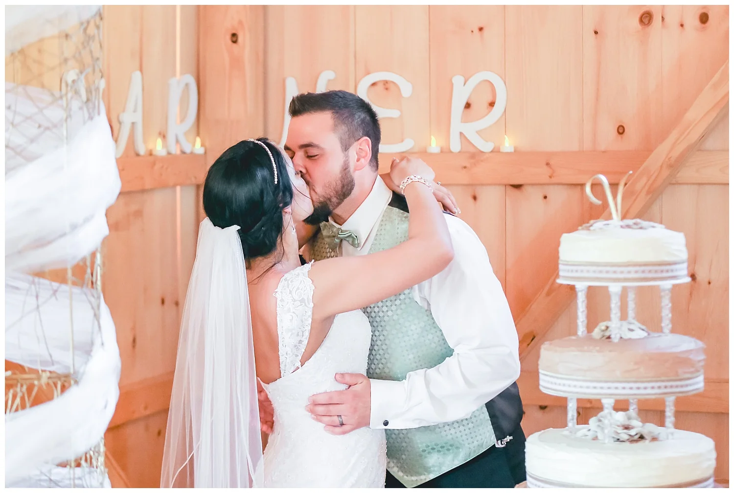 bride and groom kiss after cake cutting