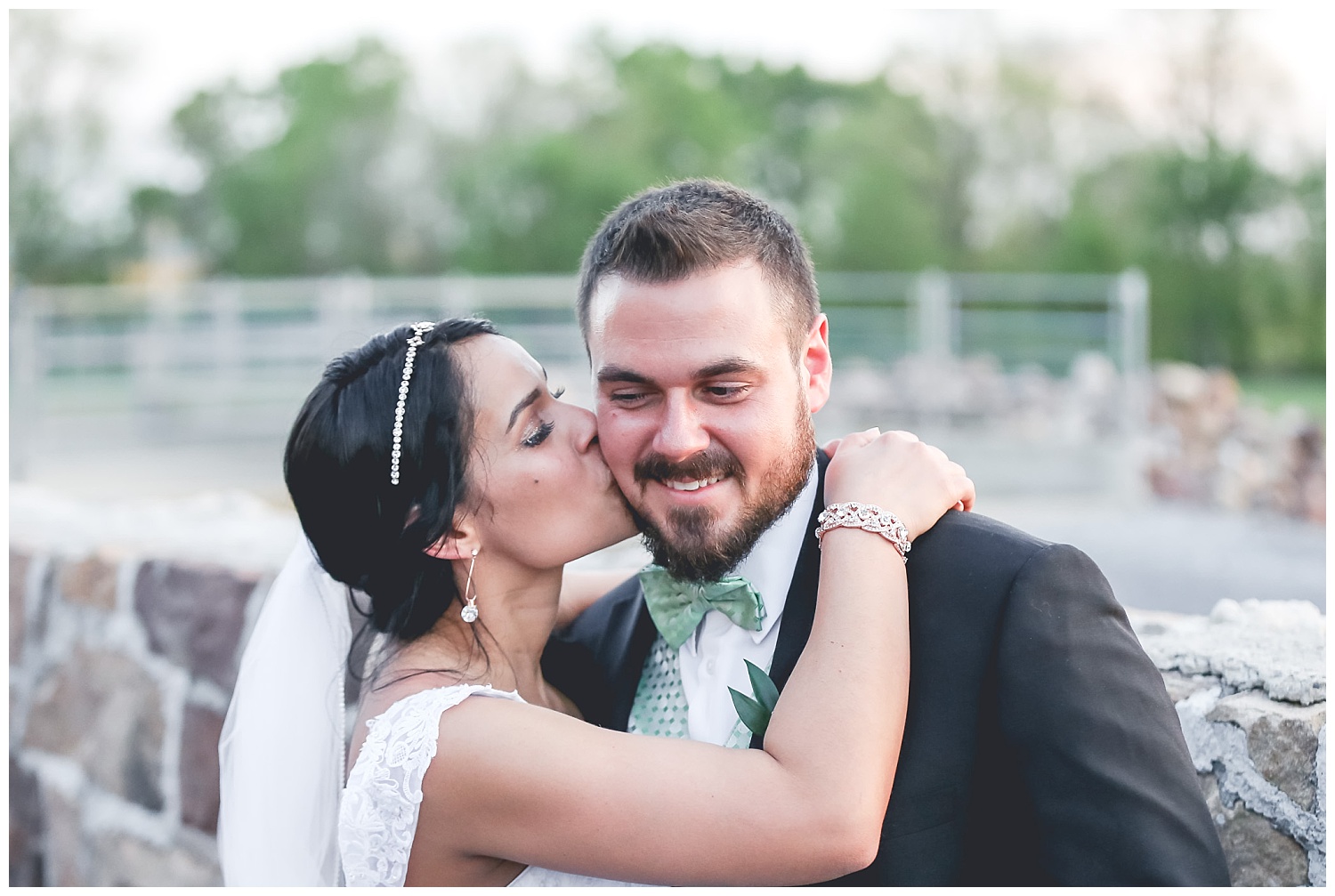 bride kisses groom on cheek