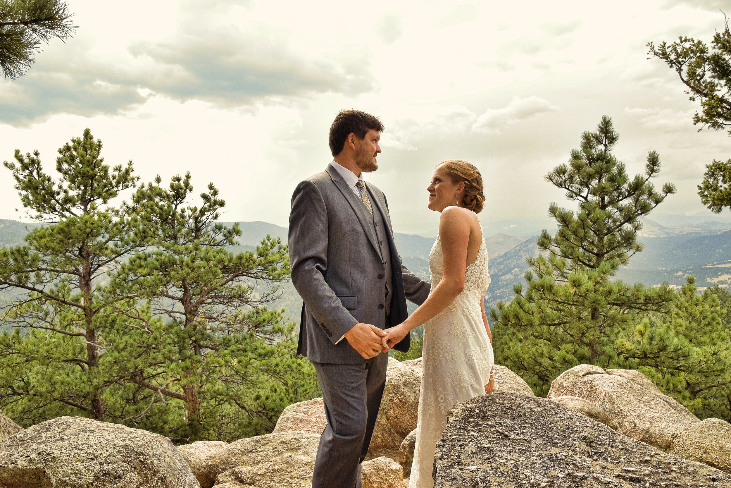 Candid shot of bride and groom in mountains.