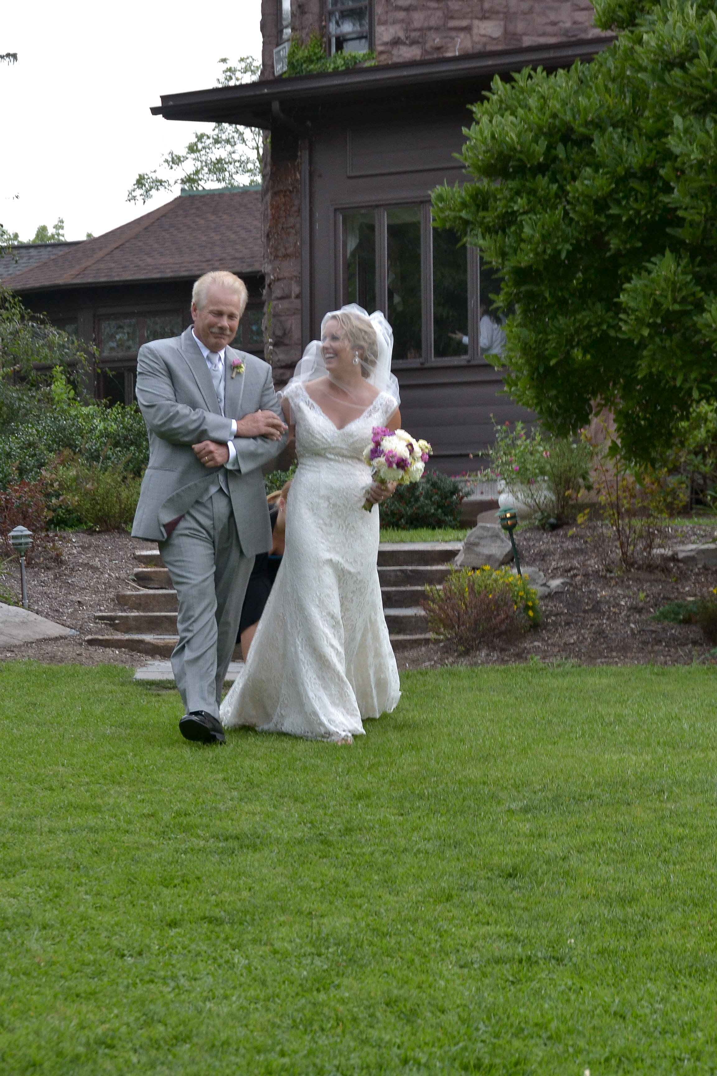 Bride with dad walking to wedding ceremony.