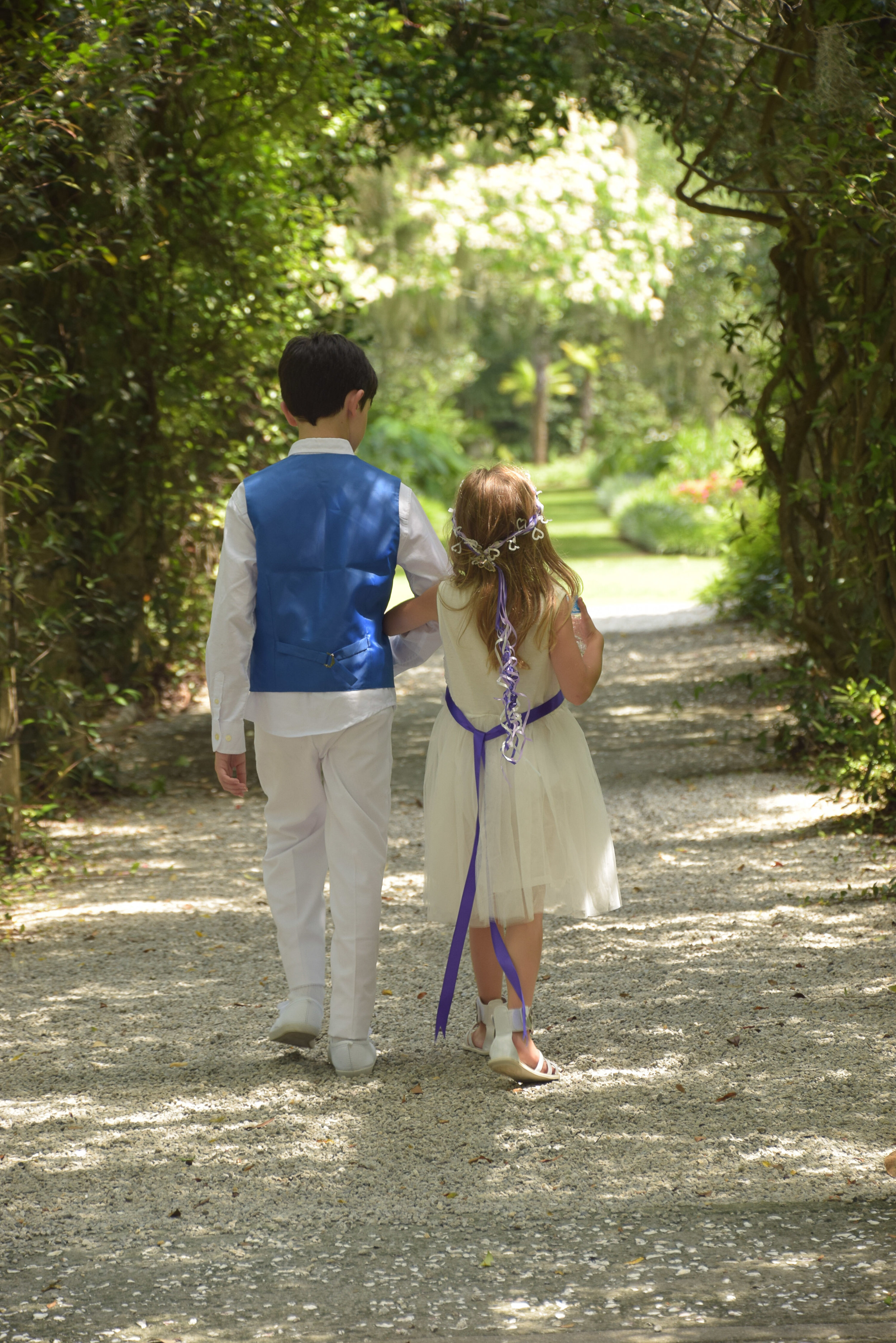 Flower girl and ring bearer walk.