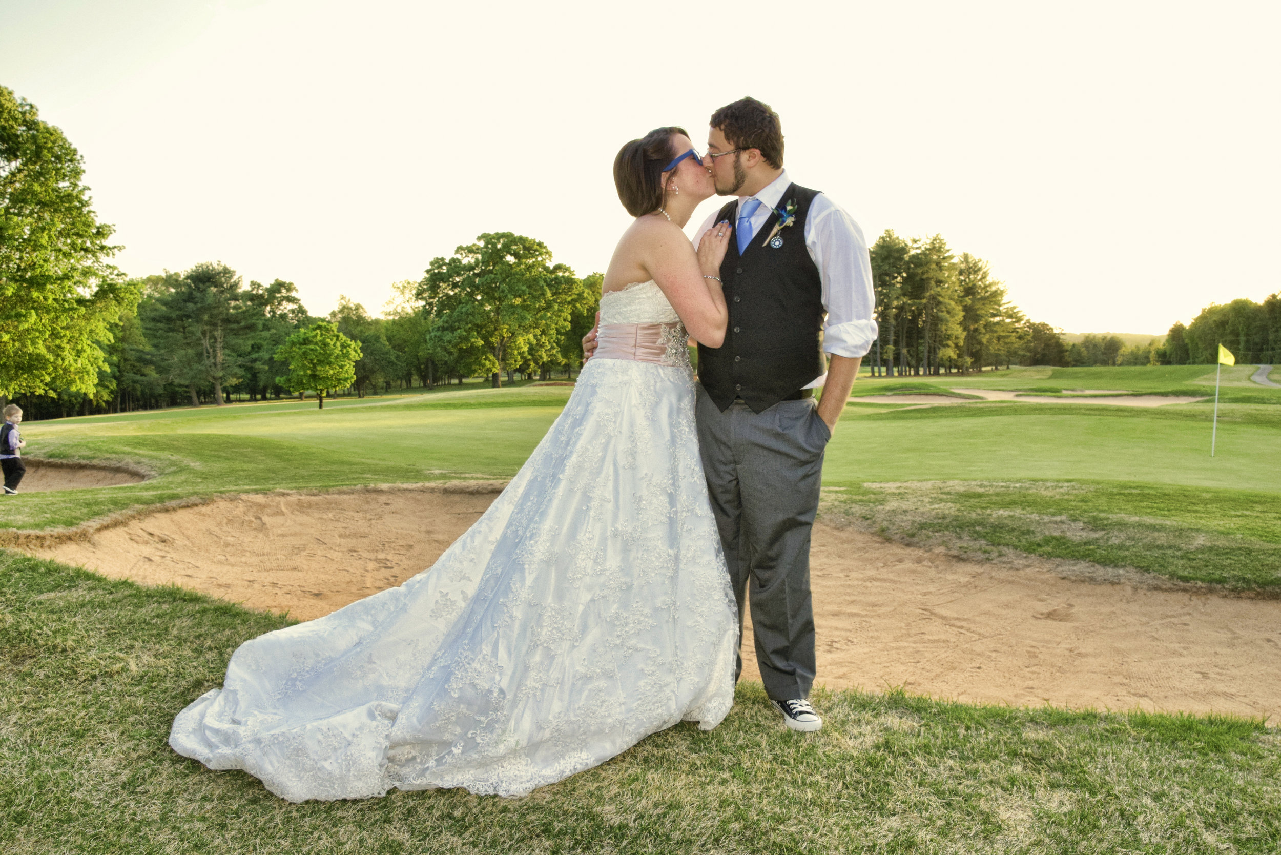 Bride and groom share a kiss.