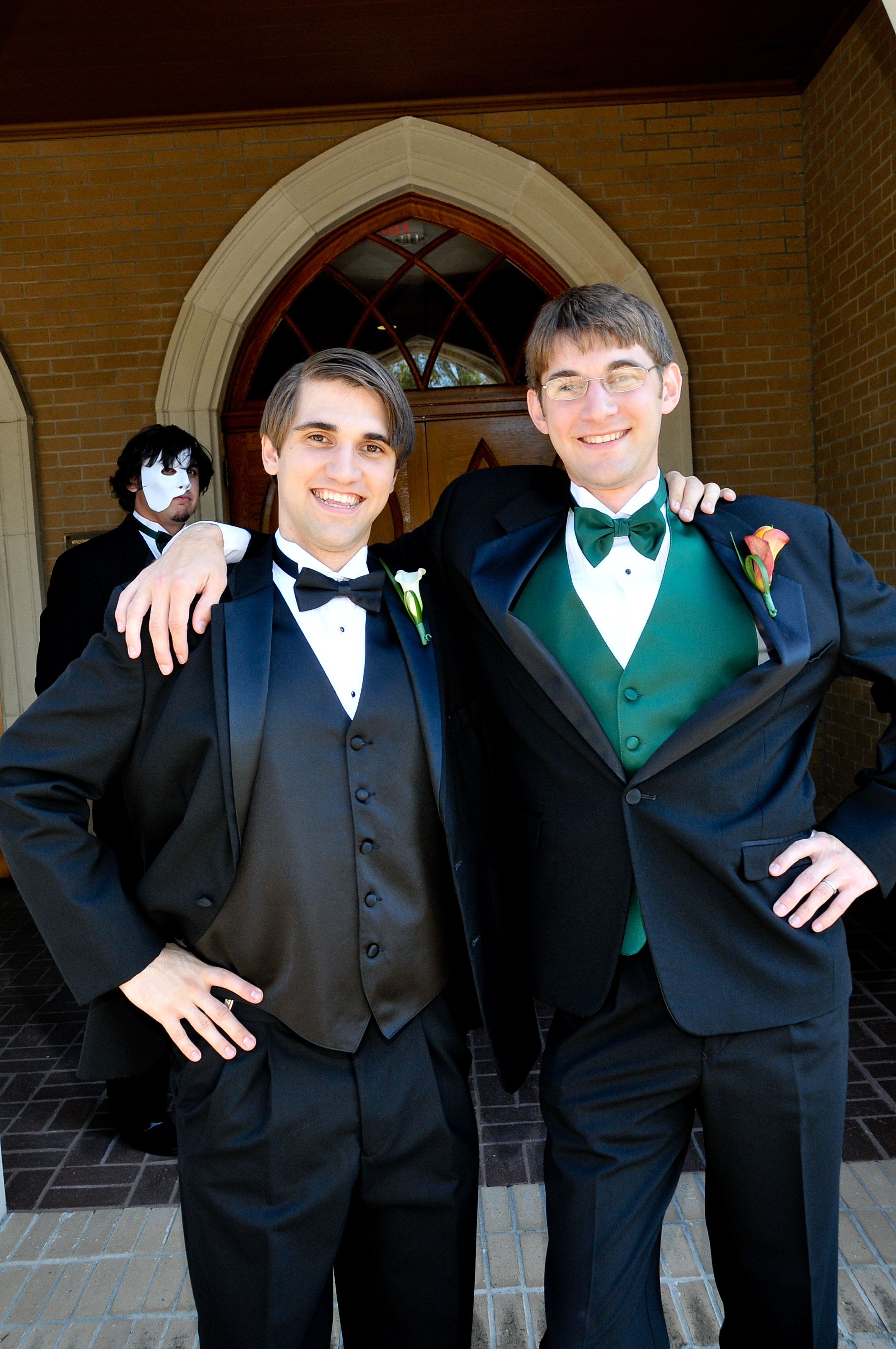 Groom and brother photobombed by Phantom of the Opera.