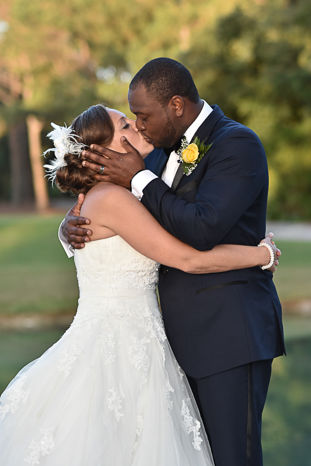 Bride and groom kiss at Porters Neck Country Club.
