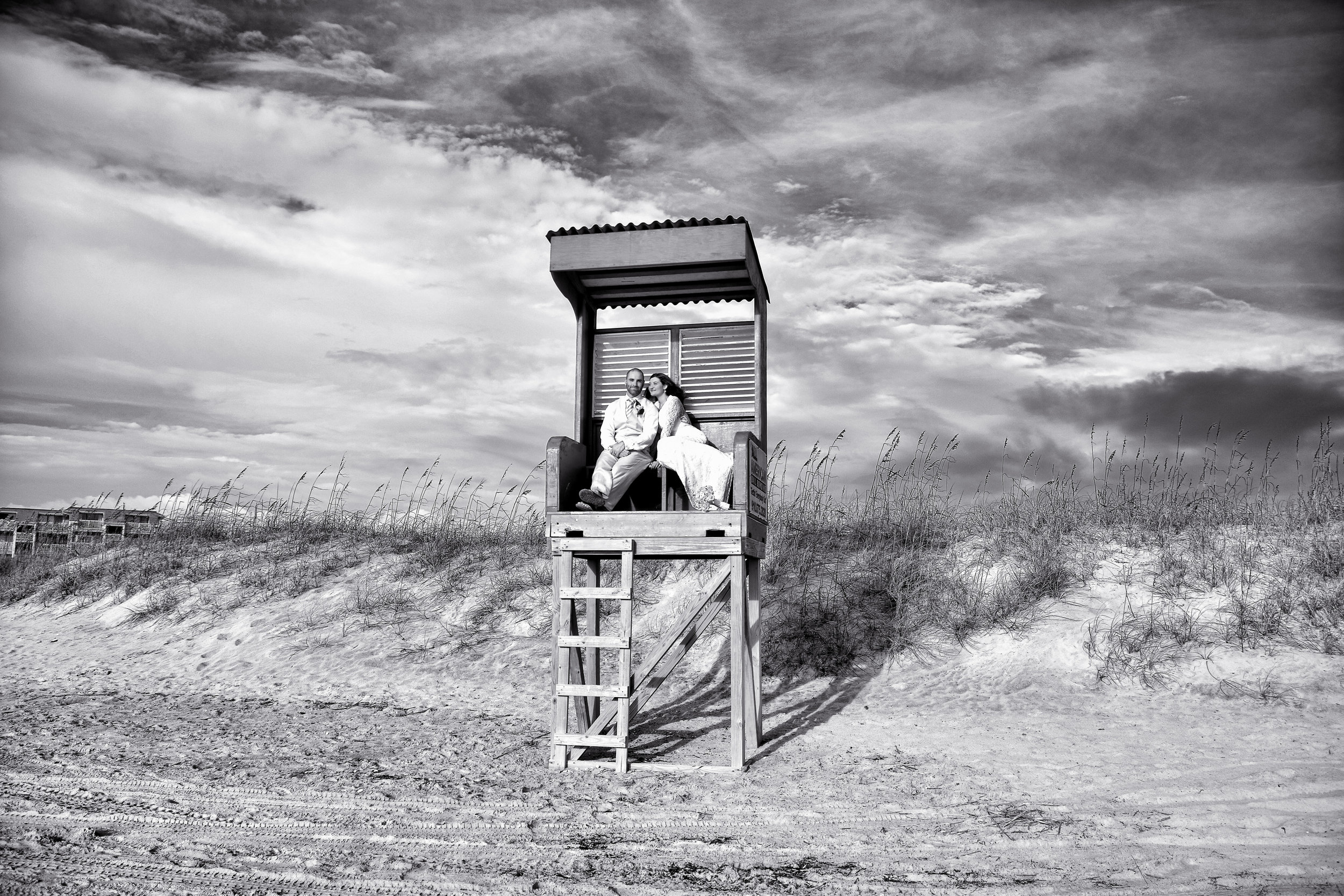 Bride and groom in lifeguard stand.