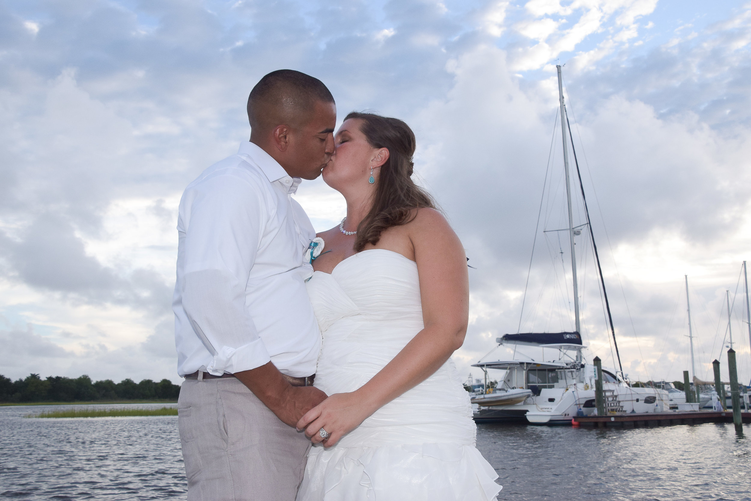 Bride and groom sharing a kiss at the Southport Marina.