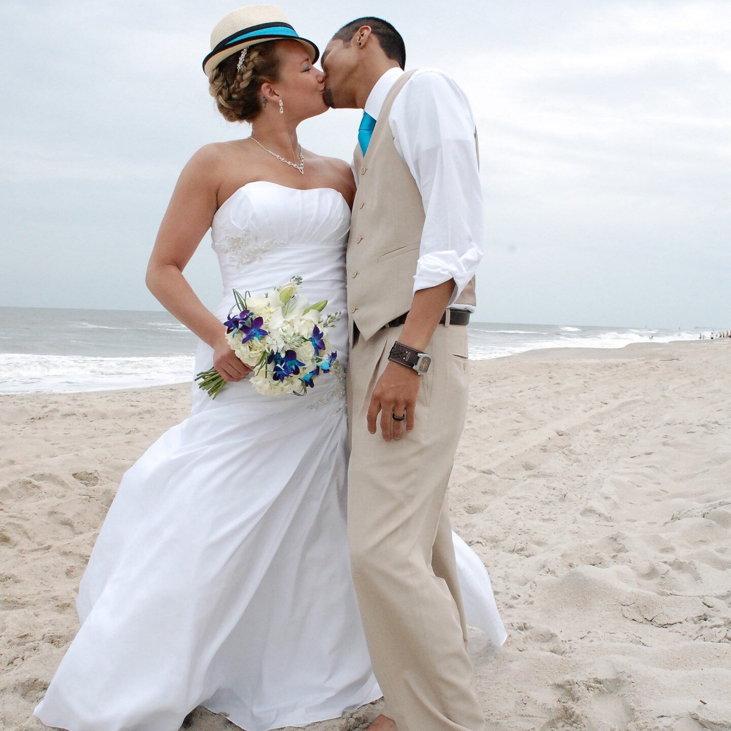 Couple on the beach, post-ceremony. From a wedding about 10 years ago. Loved this wedding. Ceremony and reception under the house with some romantic pics on the beach. Very informal and fun.

#beachweddings #beachweddingdress 
#carolinabeachwedding #