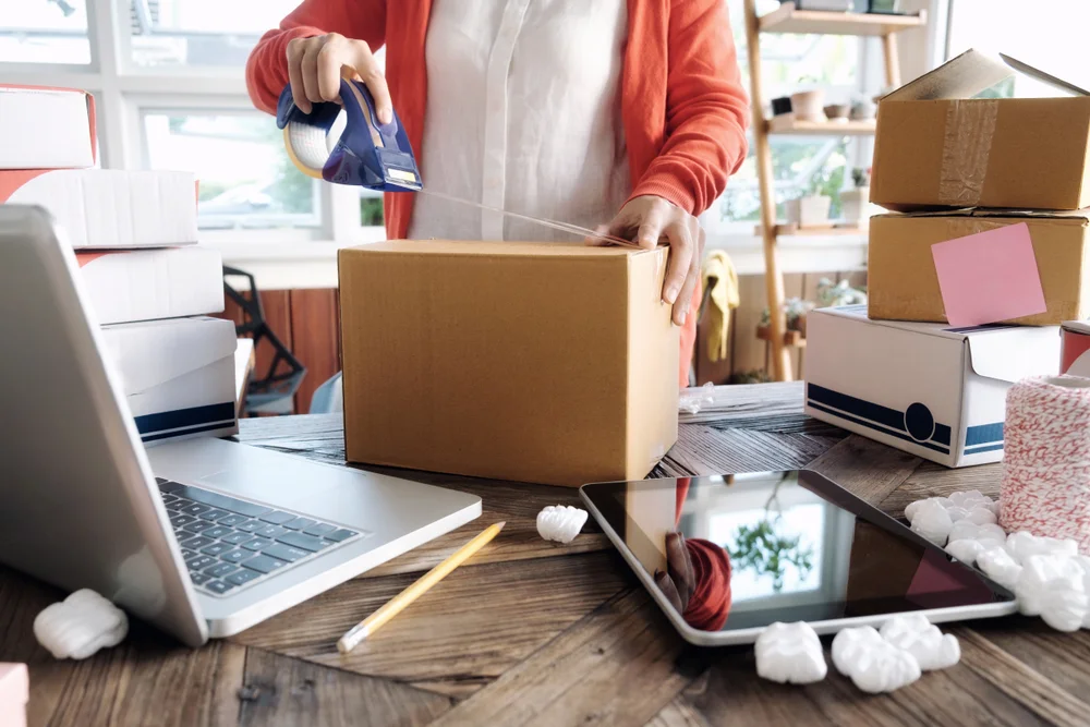 girl-packing-commerce-box-orders-for-shipping-in-office.jpg